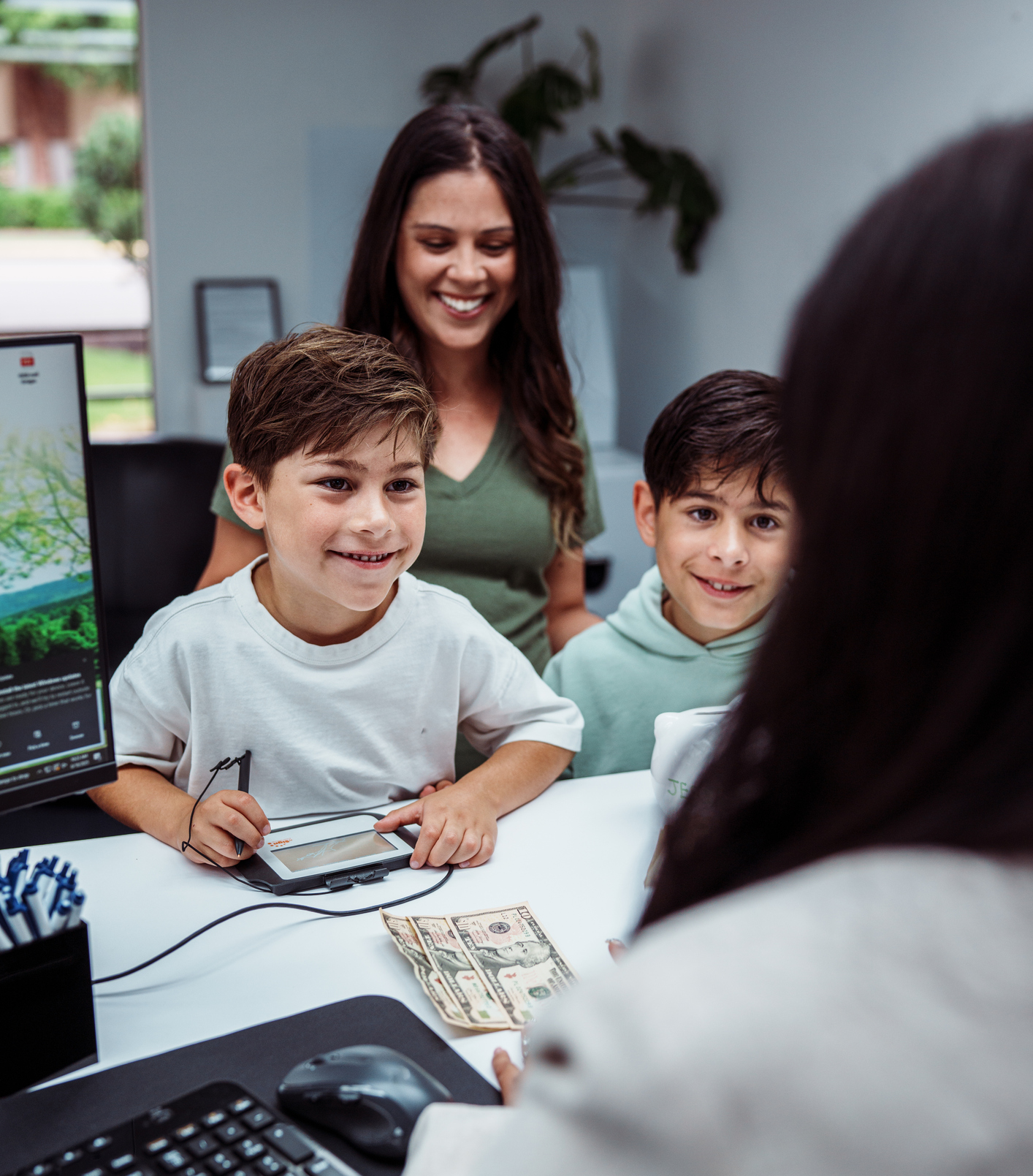 Family at bank counter, smiling interaction