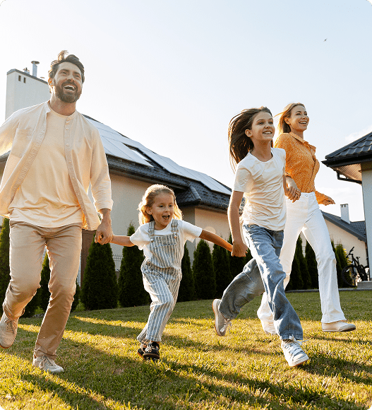 Family holding hands running on lawn