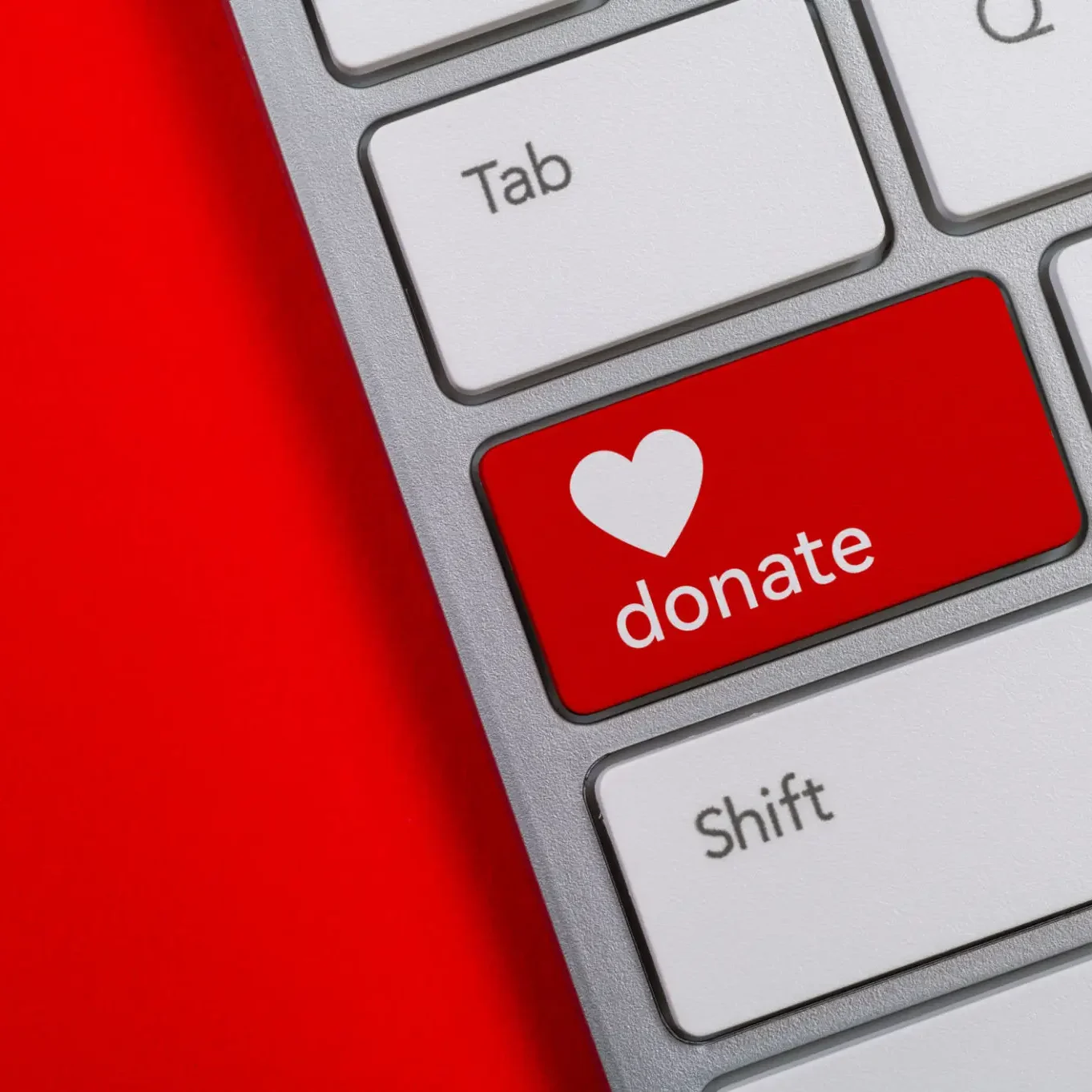 Red donate key with heart on keyboard